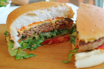 Closeup the texture of delectable cut hamburger served on wooden tray