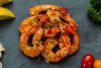 mouth watering beautiful fresh shrimps with vegetables on a stone tray