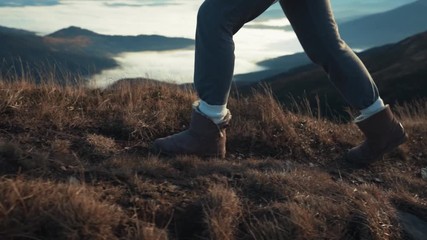 Stylish beautiful caucasian young woman walking up the hill clouds at backview blows wind relaxing enjoying the amazing view trip adventure landscape outdoor pure nature slow motion close up - Powered by Adobe