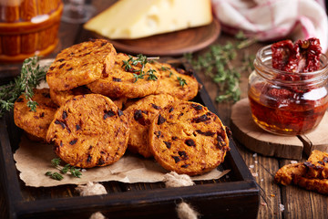 Spicy crispy cookies with cheese, sun dried tomatoes and thyme. Delicious homemade appetizer.