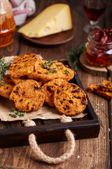 Spicy crispy cookies with cheese, sun dried tomatoes and thyme. Delicious homemade appetizer.