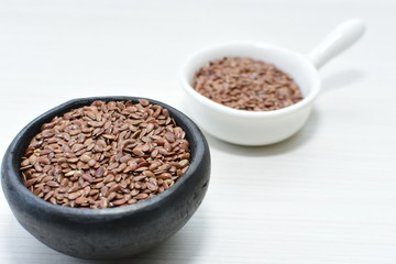 natural flaxseed seeds displayed in containers