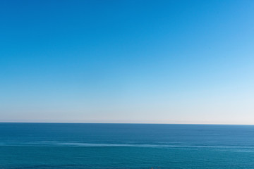 Clear sky and calm sea or ocean water surface