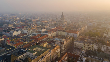 Top view shooting on a drone in the early morning. City is the capital of Hungary, sunrise of the sun. Historical part of the old city Budapest, towers St. Stephen's Cathedral.