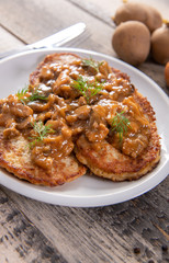 Tasty homemade potato pancakes with meat and mushrooms