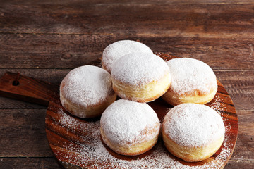 Fototapeta na wymiar German donuts with jam and icing sugar. Carnival powdered sugar raised donuts for party