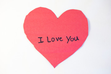 Construction craft paper heart with "I love you" written by child