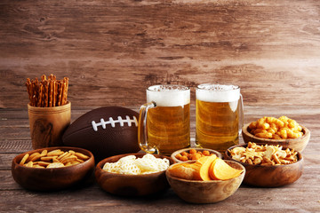 Chips, salty snacks, football and Beer on a table. Great for Bowl Game snack projects.