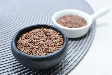  natural flaxseed seeds displayed in containers