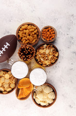 Chips, salty snacks, football and Beer on a table. Great for Bowl Game snack projects.