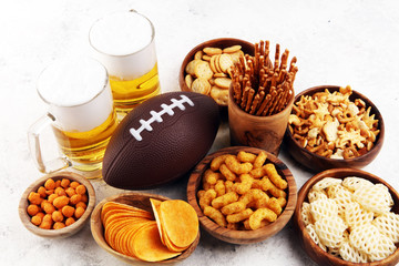 Chips, salty snacks, football and Beer on a table. Great for Bowl Game snack projects.