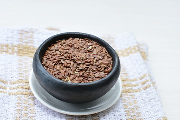  natural flaxseed seeds displayed in containers