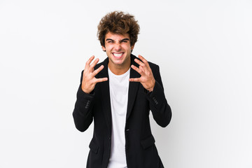Young caucasian business man against a white background isolated upset screaming with tense hands.