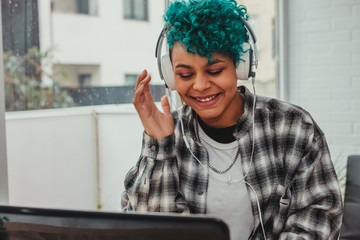 girl with computer and headphones at home or office desk