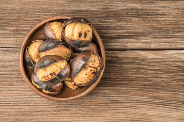 roasted chestnuts in a bowl on a wooden table