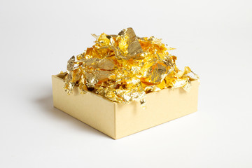 Cardboard gift box with decorative gold foil pieces isolated on white background with soft shadow, can be used for text on sides, backgrounds, compositions etc.