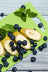 Fresh bananas and blueberries. Diet vegetarian food.