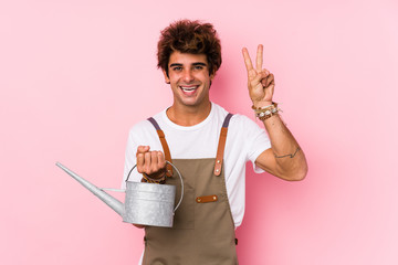 Young caucasian gardener man isolated showing number two with fingers.