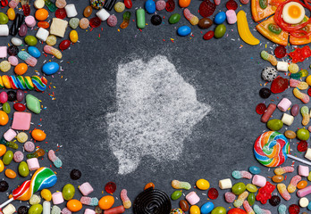 Sugar in the shape of Botswana surrounded by a variety of sweets. (series)
