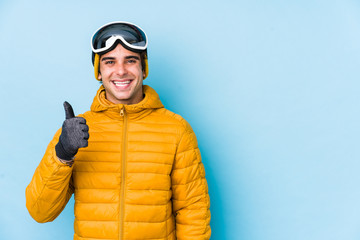 Young skier man wearing snowboard goggles isolated smiling and raising thumb up