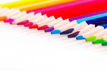 macro multicolored pencils on a white background