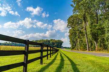 Fototapeta premium Amish country field agriculture, beautiful brown wooden fence, farm, barn in Lancaster, PA US