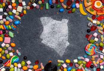 Sugar in the shape of Kenya surrounded by a variety of sweets. (series)