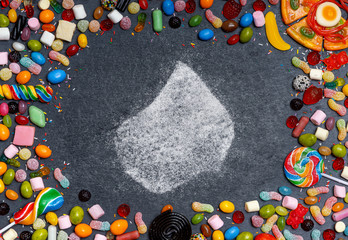 Sugar in the shape of Lesotho surrounded by a variety of sweets. (series)