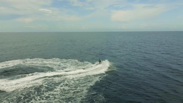 Aerial view of a motor boat sailing near the beach