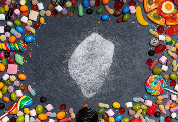 Sugar in the shape of Swaziland surrounded by a variety of sweets. (series)