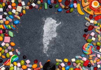 Sugar in the shape of Argentina surrounded by a variety of sweets. (series)