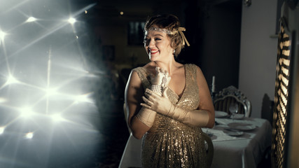 a woman in the image of 20s, looks like a frame from old films, on the head of the diodema a...
