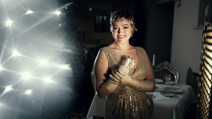 a woman in the image of 20s, looks like a frame from old films, on the head of the diodema, a...