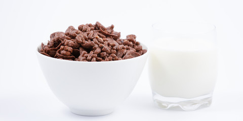 Breakfast cereal, cornflake chocolate in cups and milk is a healthy breakfast that is healthy for the body every day on a white background.