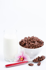 Breakfast cereal, cornflake chocolate in cups and milk is a healthy breakfast that is healthy for the body every day on a white background.