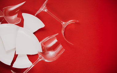 Broken Plate or broken water glass on the on the red background The concept of accidents in the...