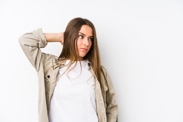 Obraz premium Young caucasian woman isolated touching back of head, thinking and making a choice.