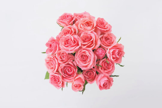 Beautiful bouquet of fresh pink roses in full bloom on white background. Bunch of flowers.