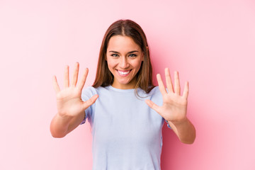 Young caucasian woman wearing a ski clothes isolated showing number ten with hands.