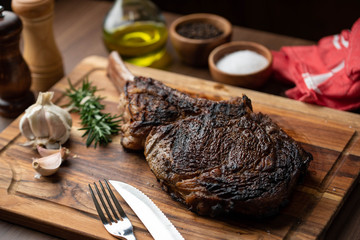 grilled tomahawk steak on wooden plate ready for eat