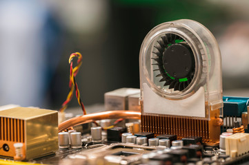 Fan with a brass radiator on a computer board.