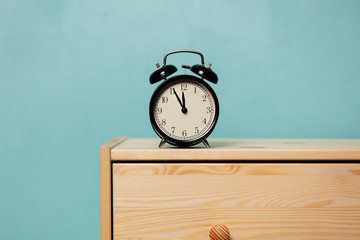 vintage alarm clock on  bedside table