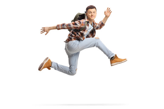 Male student jumping high and smiling