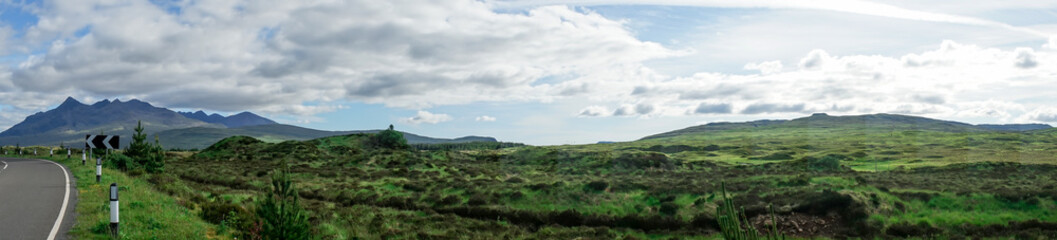 Fototapeta premium Panorama of clear, green highlands at the roadside