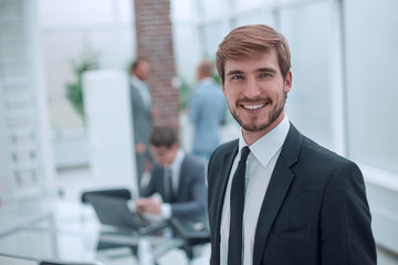 close up. smiling businessman standing in his office.