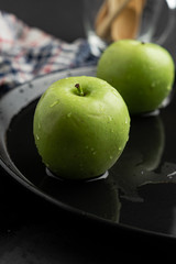 Photography of Verdews apples in black and water background