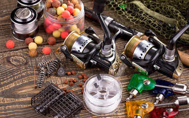 fishing tackle on a wooden table. toned image