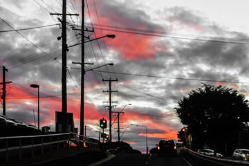Sky on fire above evening commute home in Brisbane Australia with utility wires everywhere