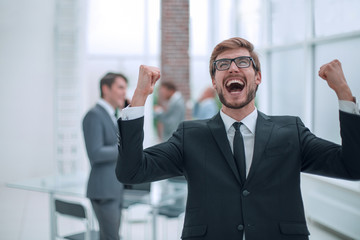 portrait of a very happy businessman on an office background