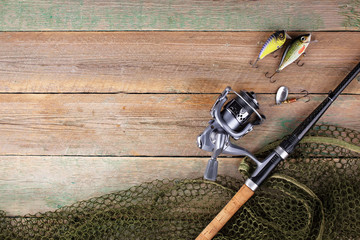 fishing tackle on a wooden table.